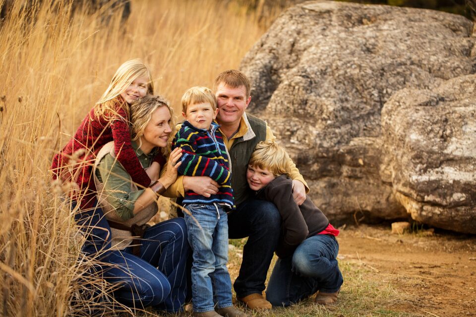 Cape Girardeau newborn photographer, perryville photographer, Farmington newborn photographer, winter photoshoot, family hugging, big rocks, Perry county community lake