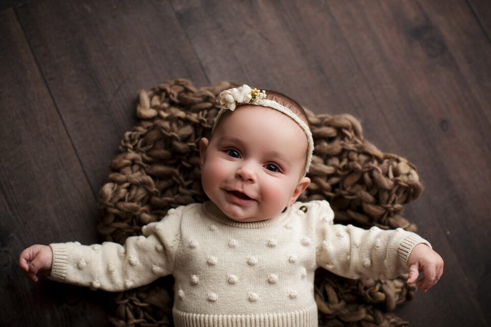 perryville newborn photographer, Cape Girardeau photographer, baby girl smiling, rustic backdrop
