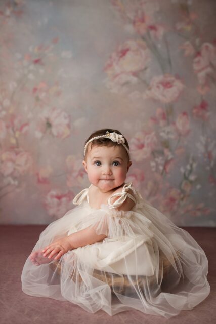perryville newborn photographer, Cape Girardeau photographer, white dress, floral backdrop, intuition backgrounds, baby girl sitting up