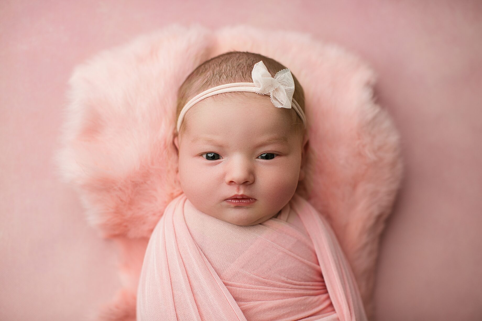 Perryville newborn photographer, southeast Missouri newborn, Cape Girardeau newborn photographer, awake baby, pink backdrop, photography studio newborn, baby girl looking at camera