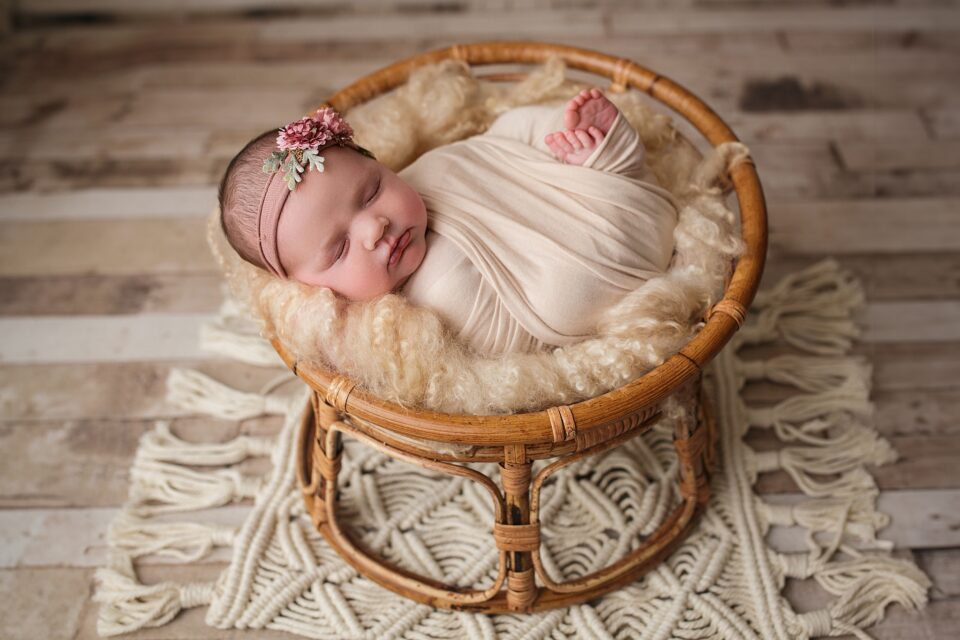 Cape Girardeau newborn photographer, perryville newborn photographer, baby sleeping, papasan chair, baby girl with pink flower, macrame