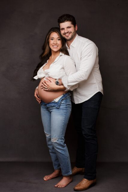 perryville maternity photographer, Cape Girardeau maternity photographer, studio pregnancy photos, studio photos, dark backdrop, intuition backgrounds, husband and wife maternity, belly