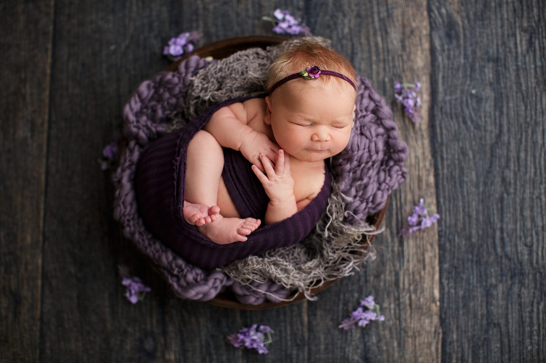 Cape Girardeau newborn photographer, Farmington newborn photographer, perryville newborn photographer, wood backdrop, purple newborn photo setup, violet, blonde hair