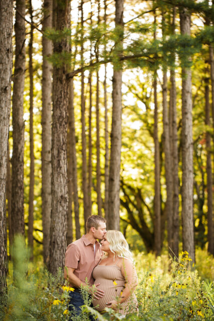 perryville maternity photographer, Cape Girardeau maternity photographer, tall trees, light coming through trees, wild flowers, baby belly, pregnancy