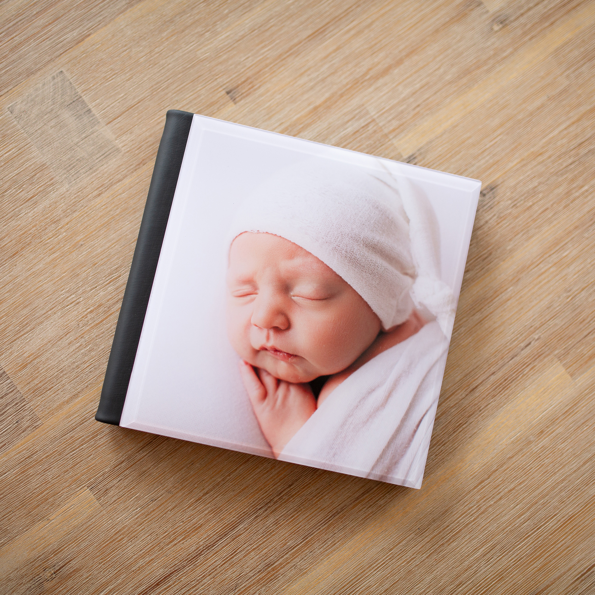 perryville missouri newborn photographer, Jackson Missouri newborn photographer, album, baby on book, wood table, Cape Girardeau newborn photographer