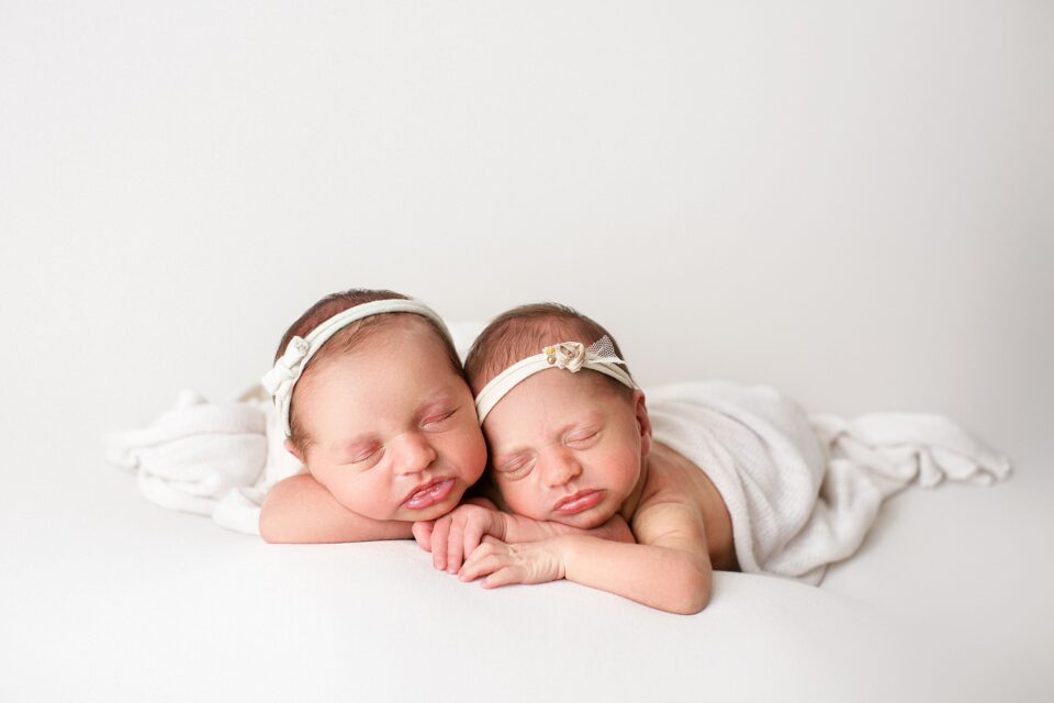 st Louis Missouri Newborn photographer, CAPE GIRARDEAU Missouri Newborn photographer, perryville newborn photographer, twins, white blanket, babies sleeping, girl twins, neutral twin photoshoot
