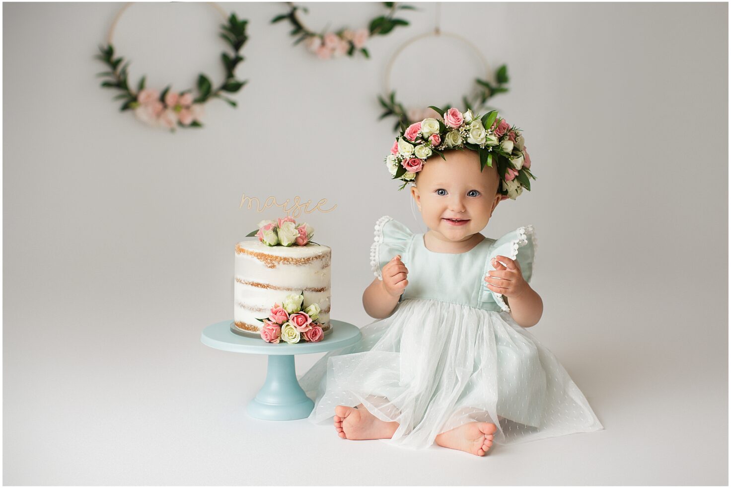 perryville missouri newborn photographer, Cape Girardeau missouri newborn photographer, Jackson Missouri newborn photographer, farmington missouri newborn photographer, baby looking at camera, simple cake, blue dress, floral headband