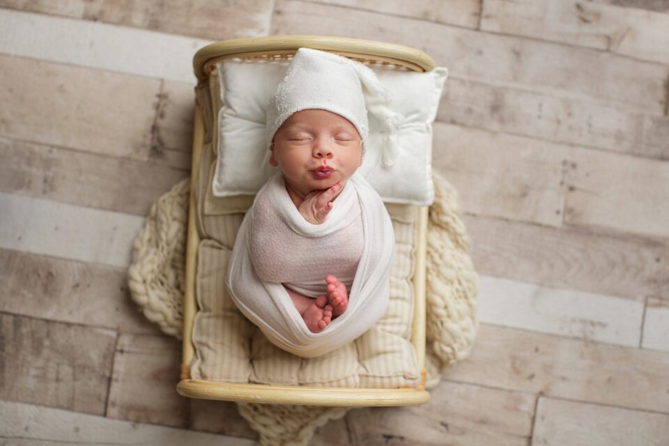 st Louis missouri newborn photographer, photography, Perryville Missouri newborn photographer, Missouri newborn photographer, baby, white blanket, baby sleeping, baby boy, newborn photo, white hat, pucker lips