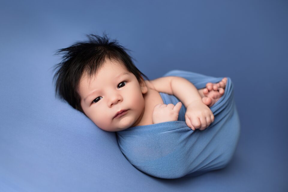 Perryville newborn photographer, Cape Girardeau newborn photographer, baby laying on blue blanket, baby boy, photoshoot, newborn baby