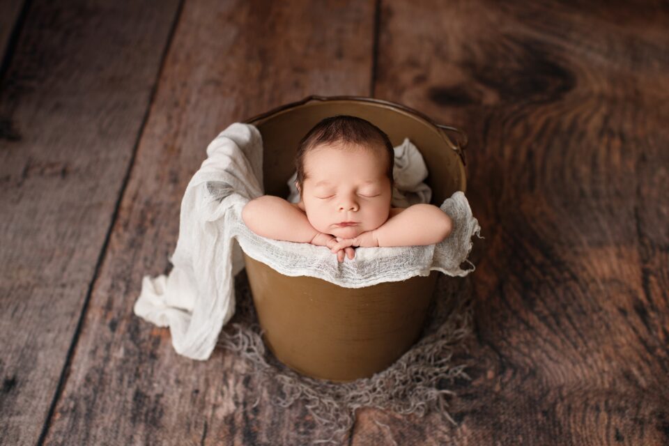 perryville newborn photographer, Cape Girardeau newborn photographer, Missouri Newborn photographer, lots of hair, baby photoshoot, baby in bucket, baby sleeping, ste. Genevieve newborn photographer