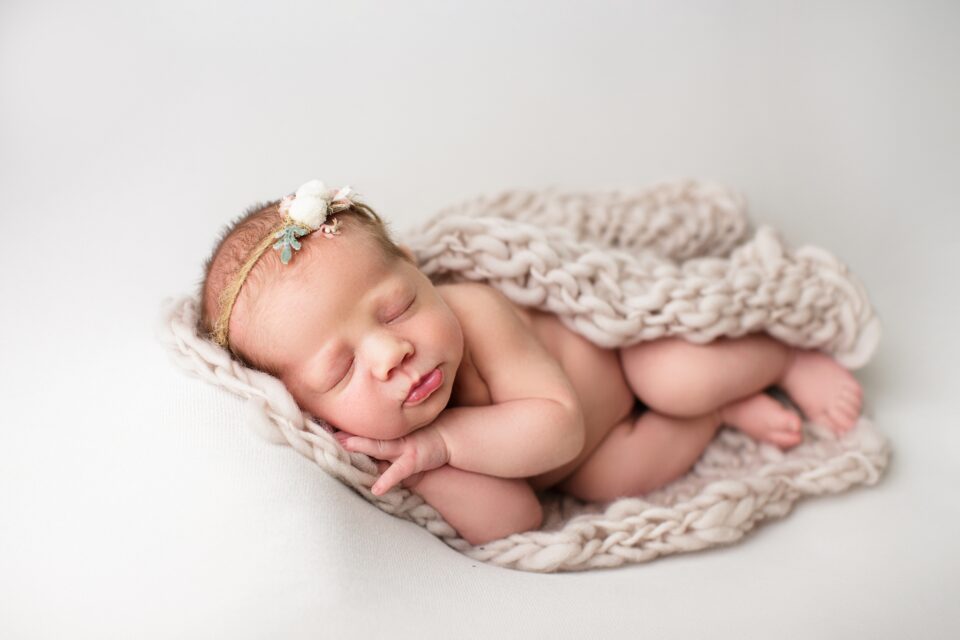 Cape Girardeau newborn photographer, baby laying on side, chunky blanket, newborn girl photoshoot