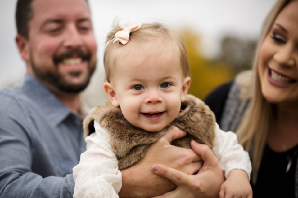 Farmington newborn photographer, Cape Girardeau photographer, perryville photographer, parents holding baby, baby smiling, parents looking at baby
