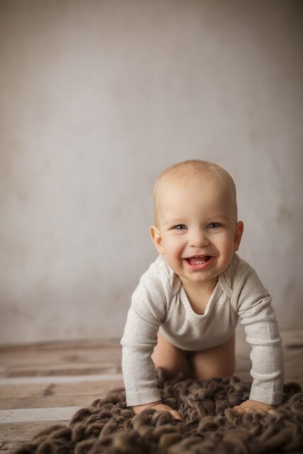 Cape Girardeau newborn photographer, perryville photographer, cute baby, neutral photo session, rustic backdrop, baby showing teeth