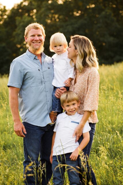 Farmington newborn photographer, perryville newborn photographer, dad looking at camera, green grass