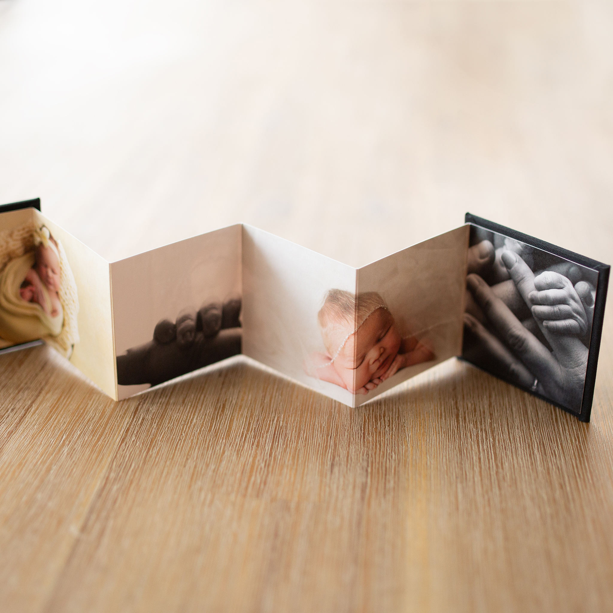 perryville Missouri newborn phtographer, Jackson Missouri newborn photographer, accordion book, baby, wood table, st Louis Missouri newborn photographer