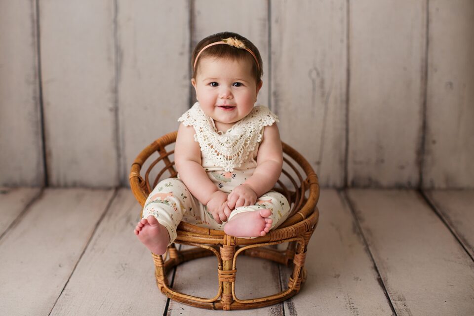 st Louis newborn photographer, perryville Missouri Newborn photographer, arch, sitter session, baby girl, papasan chair, wood floor, studio session