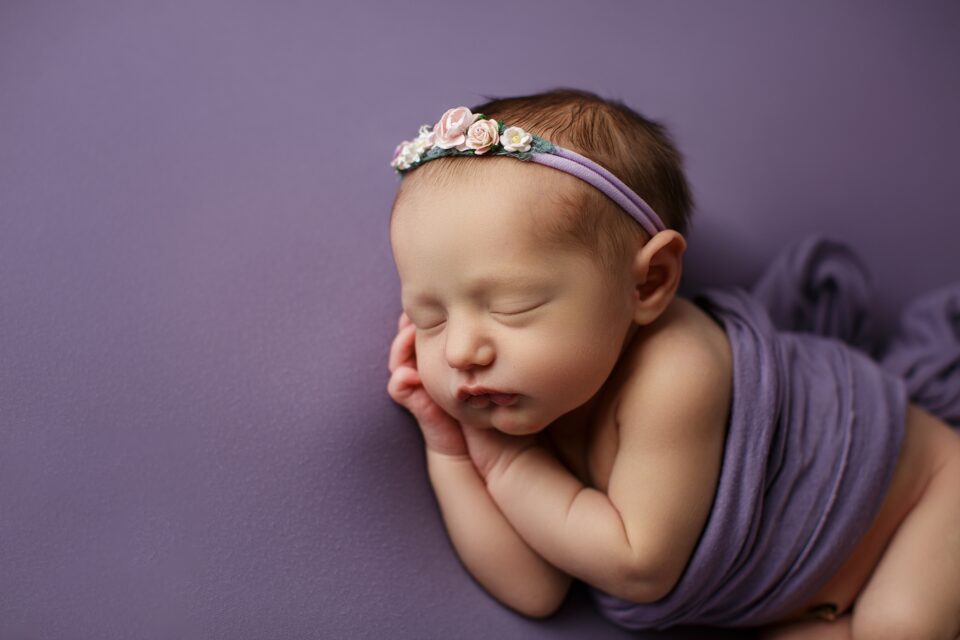 farmington Missouri Newborn photographer, CAPE GIRARDEAU newborn photographer, st Louis Missouri Newborn photographer, purple headband, flowers, baby on side, sleeping