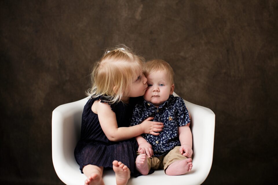 st Louis newborn photographer, farmington Missouri Newborn photographer, cape girardeau Missouri Newborn photographer, perryville, sister kissing brother, white chair