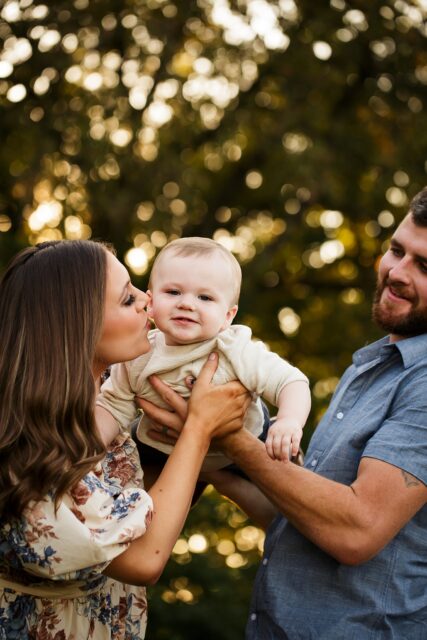 st Louis newborn photographer, farmington Missouri Newborn photographer, cape girardeau Missouri Newborn photographer, perryville family photographer, bokeh, mom kissing son, outside family portraits